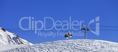 Panoramic view on gondola lift and ski slope