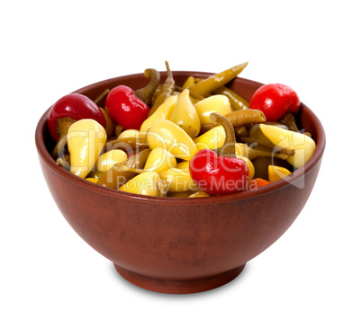 Mix of hot turkish marinated peppers in ceramic bowl