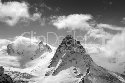 Black and white winter mountains in clouds