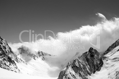 Black and white winter snowy mountains in cloud