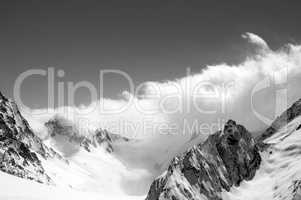 Black and white winter snowy mountains in cloud