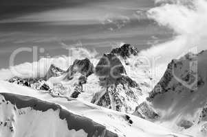 Black and white winter mountains with snow cornice