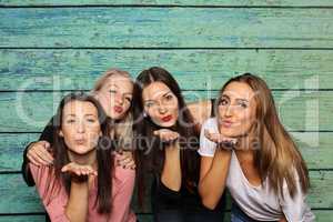4 Mädchen machen Pusteküsse in eine Fotobox