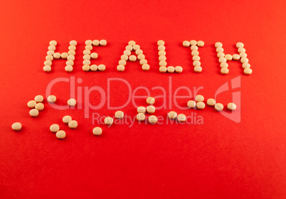 Health word written with pills of supplement