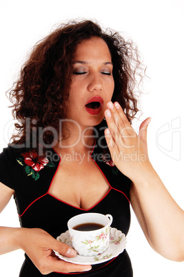 Tired woman holding coffee cup.