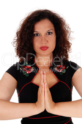 Woman folding hands and praying.