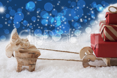 Reindeer With Sled, Blue Bokeh And Stars Background, Copy Space
