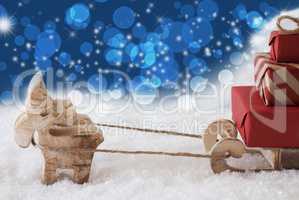 Reindeer With Sled, Blue Bokeh And Stars Background, Copy Space
