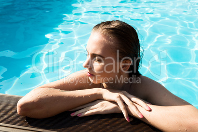 fashion photo of beautiful glamour young woman in bikini posing in summer on the swimming pool having fun and tanned. leisure and recreation concept