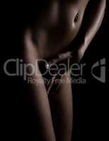 view of beautiful female stomach naked body on a black background
