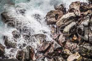 Waves hitting rocks during a storm