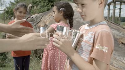 Kids hands out Tincan Phones