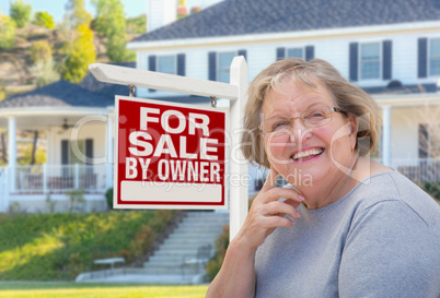 Senior Adult Woman in Front of Real Estate Sign, House