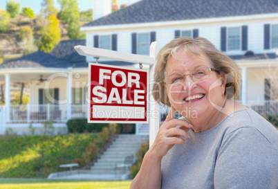Senior Adult Woman in Front of Real Estate Sign, House