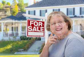 Senior Adult Woman in Front of Real Estate Sign, House