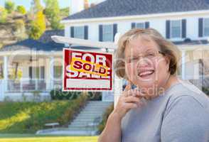 Senior Adult Woman in Front of Real Estate Sign, House