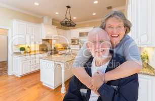 Senior Couple Hugging Inside Custom Kitchen