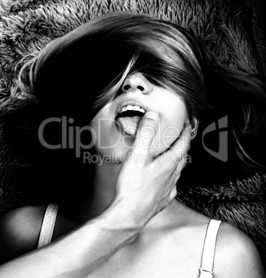 Pretty young woman enjoying with boyfriend, his finger in her mouth