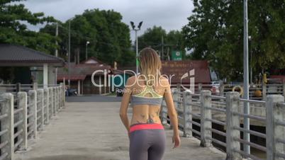 Fitness pretty blonde woman at the harbour in the morning