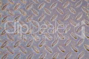 Old metal plate with raised pattern,