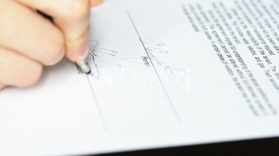 Light closeup of businessman showing his new business partner where to sign an rental agreement or contract with fountain pen and renter and landlord signing the rental contract