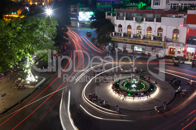 Night traffic on the square with motion trails. Hanoi, Vietnam
