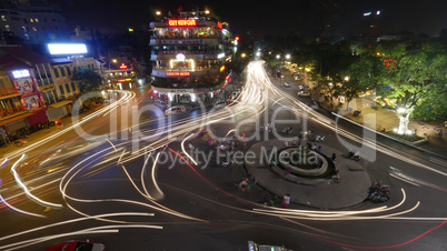 City square with traffic in motion at night. Hanoi, Vietnam