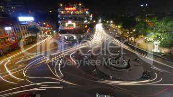 City square with traffic in motion at night. Hanoi, Vietnam