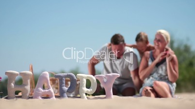 Blurred background of family having rest on beach