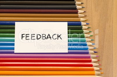 Feedback text concept over pencil background