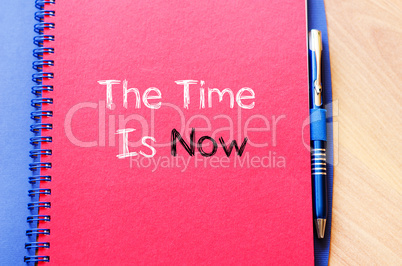 The time is now text concept on notebook