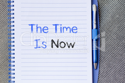 The time is now text concept on notebook