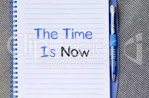 The time is now text concept on notebook
