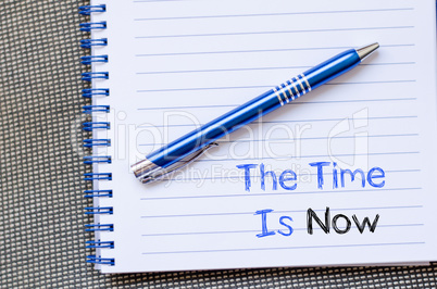 The time is now text concept on notebook