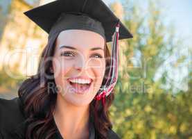 Happy Graduating Mixed Race Woman In Cap and Gown