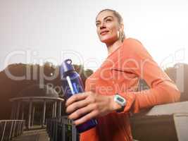 Young beautiful woman doing fitness in a park.