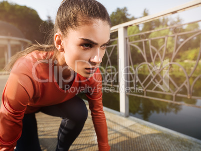 Young beautiful woman doing fitness in a park.