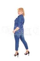 Woman in jeans clothing standing.