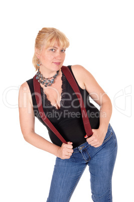 Pretty woman standing with suspenders.