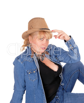 Woman with hat sitting on floor.
