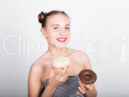 young woman in bright makeup eating a tasty donut with icing. Funny joyful woman with sweets, dessert. dieting concept. junk food. girl licking their fingers