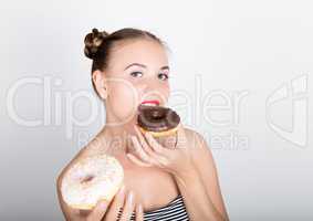 young woman in bright makeup eating a tasty donut with icing. Funny joyful woman with sweets, dessert. dieting concept. junk food. girl licking their fingers