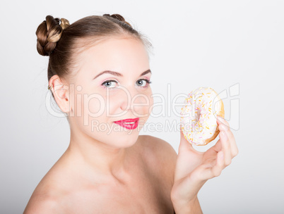 young woman in bright makeup eating a tasty donut with icing. Funny joyful woman with sweets, dessert. dieting concept. junk food. girl licking their fingers