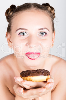 young woman in bright makeup eating a tasty donut with icing. Funny joyful woman with sweets, dessert. dieting concept. junk food. girl licking their fingers