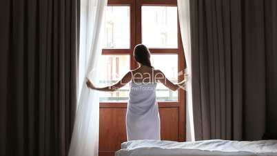 morning at the hotel. young girl in Bathrobe opens a door to balcony. Full HD. 1920x1080.