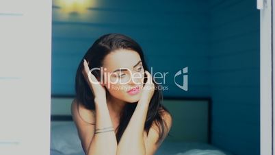 Closeup portrait of young beautiful smiling woman looking out window and enjoying morning sunlight