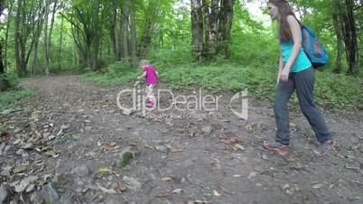 small child walking in the forest. Trips to nature. Community children with nature. Fresh and healthy air in the coniferous forest. Slow motion. Full HD. 1920x1080