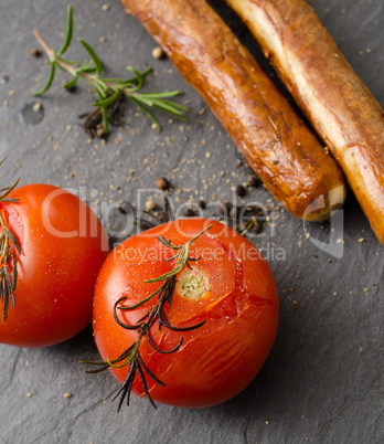 Grilled tomatoes with sausages