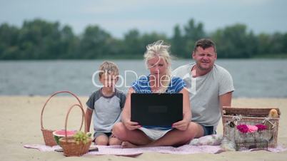 Family using laptop to talk to grandmom