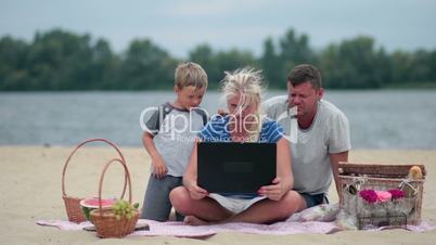 Family talking with grandparents using laptop